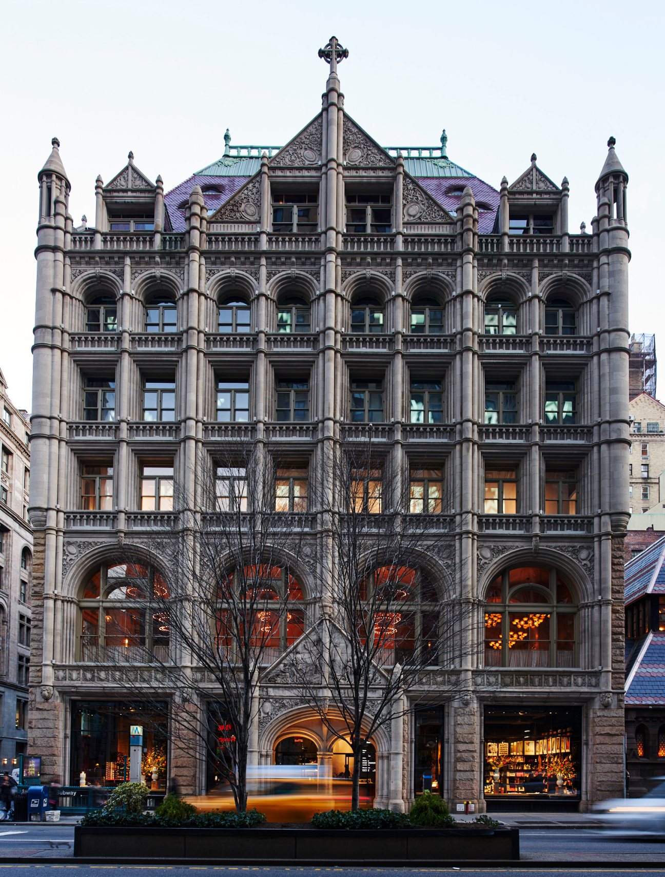 Historic stone building with ornate Romanesque Revival architecture featuring arched windows and detailed stonework