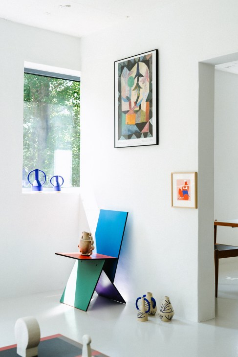 Interior of Pakkookii vintage and contemporary home décor store showing artwork, colorful furniture, ceramics and blue vases.