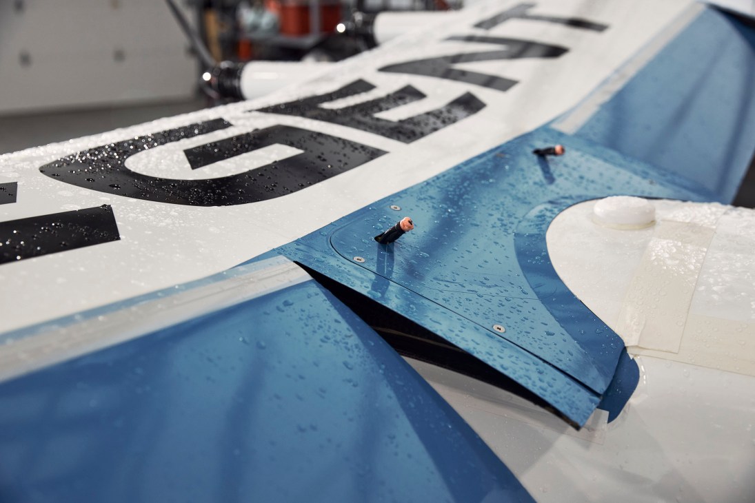 Close-up of blue and white sea glider wing covered in water droplets after testing