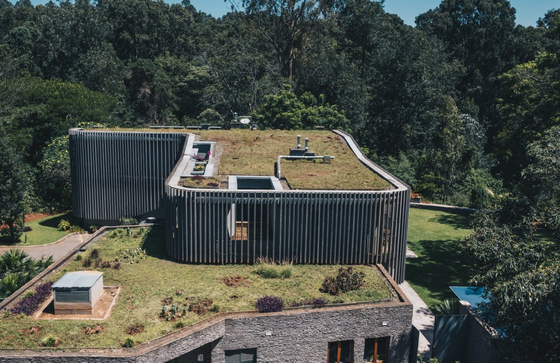 Aerial view of French embassy building with green rooftop garden and wooden slatted exterior walls