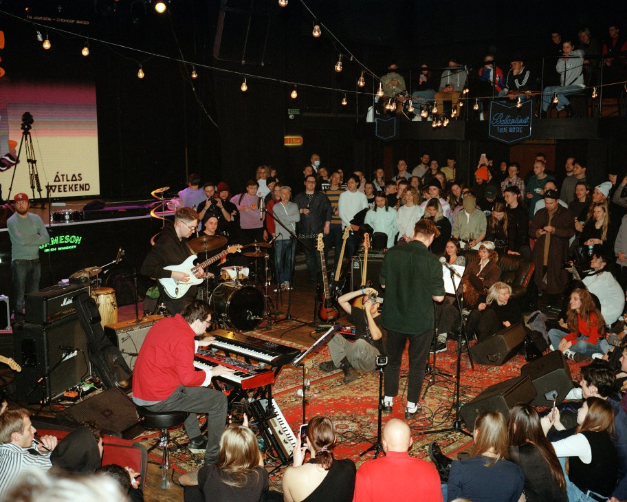 Crowded jazz concert venue with audience and musicians performing on stage