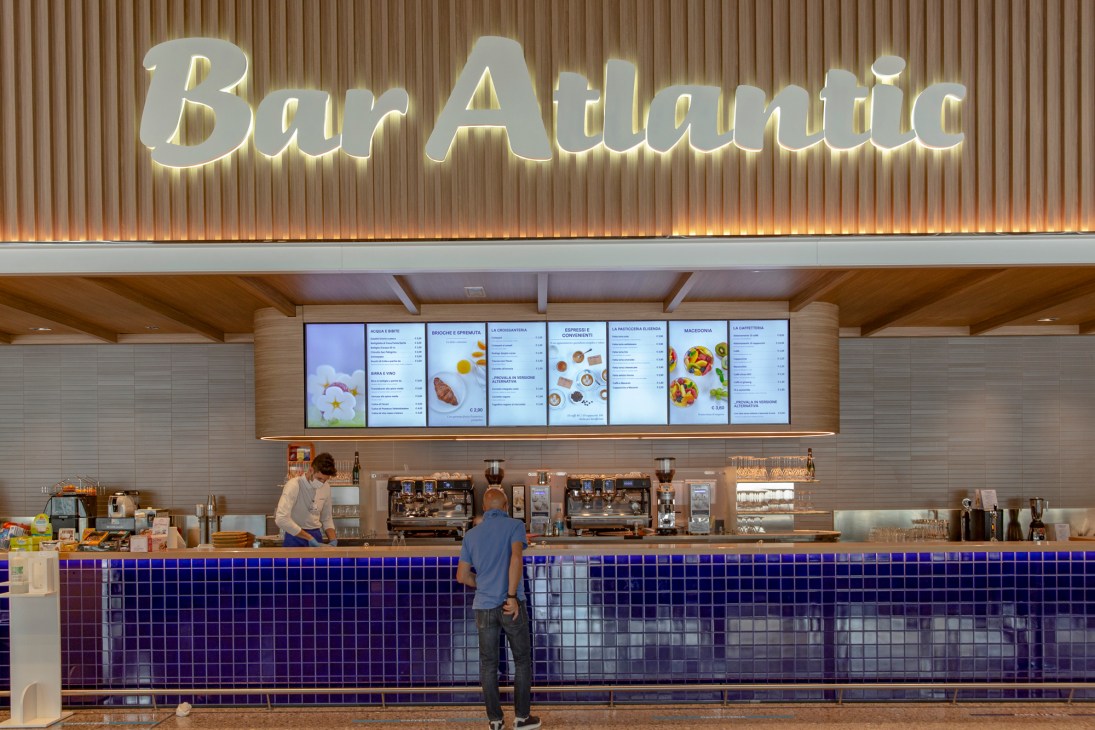 Modern supermarket bar counter with blue tile base where customers sit and dine
