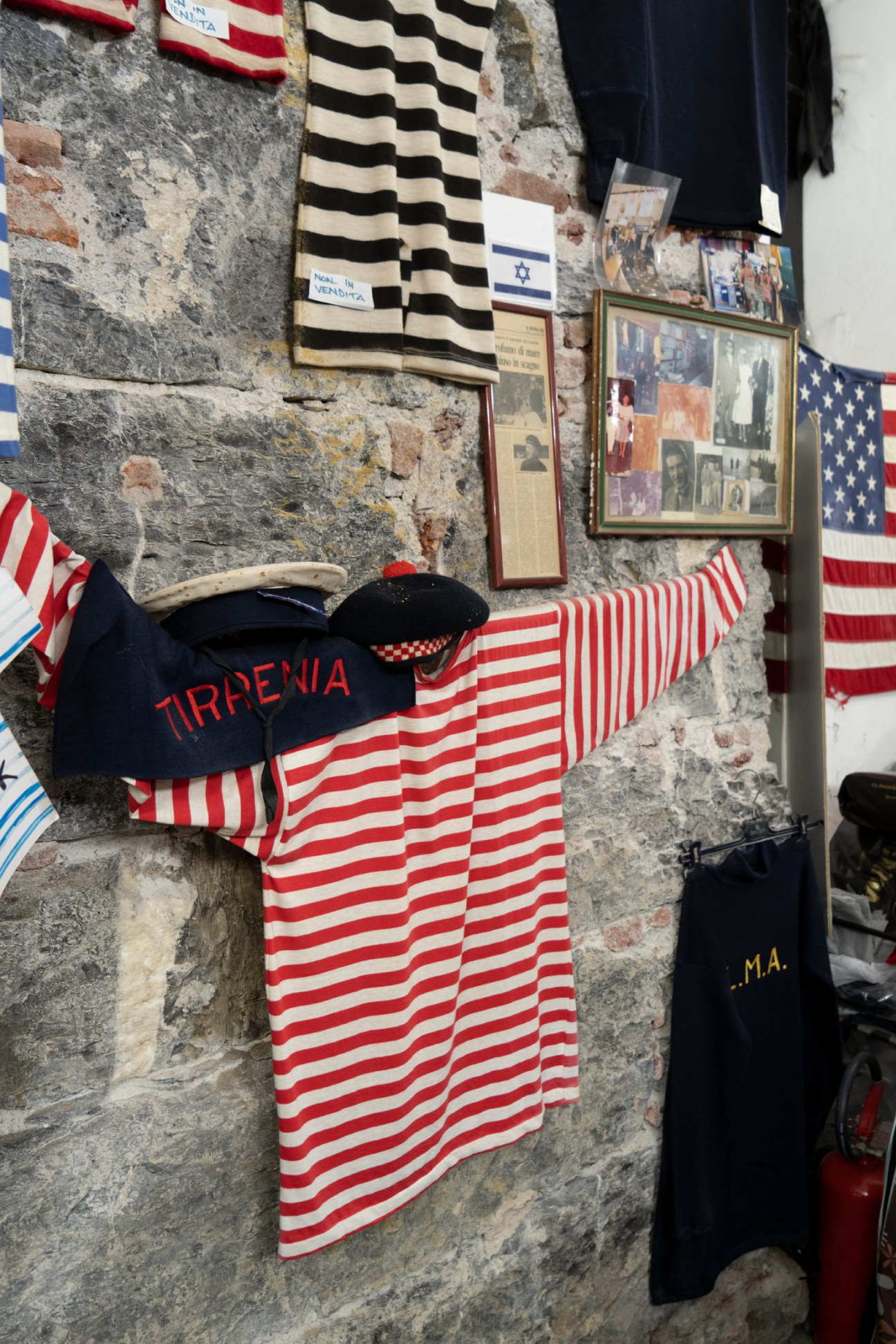 Display of striped maritime shirts and nautical clothing at Lucarda shop in Genoa