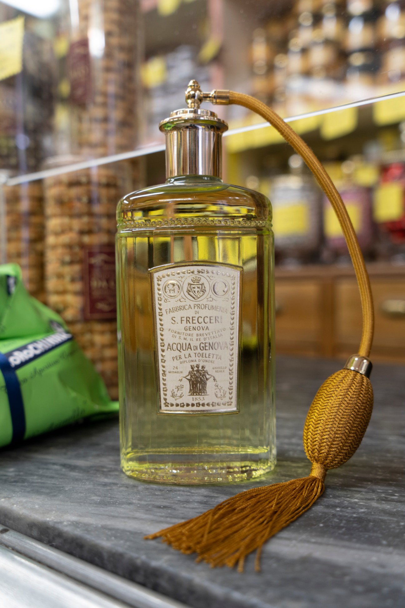 Shelves stocked with bottles, jars and packaged goods at Antica Drogheria Casaleggio grocery store