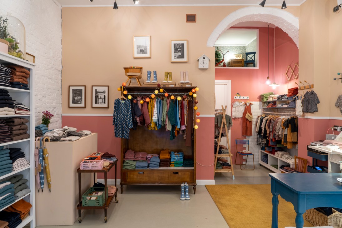 Colorful children's clothing displayed on hangers in a boutique shop