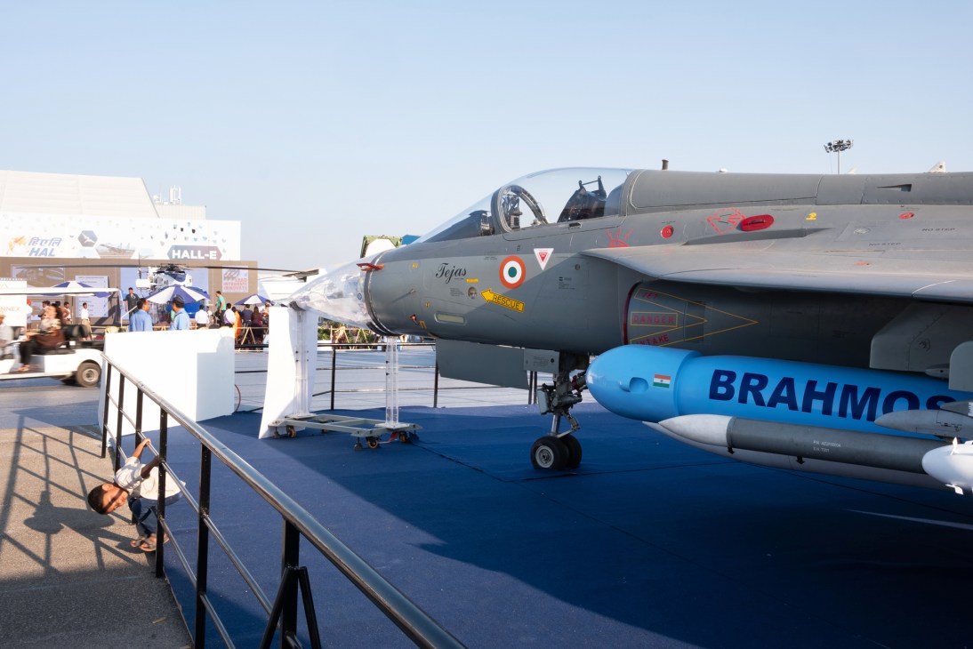 Military aircraft on display with BrahMos missile at aviation exhibition