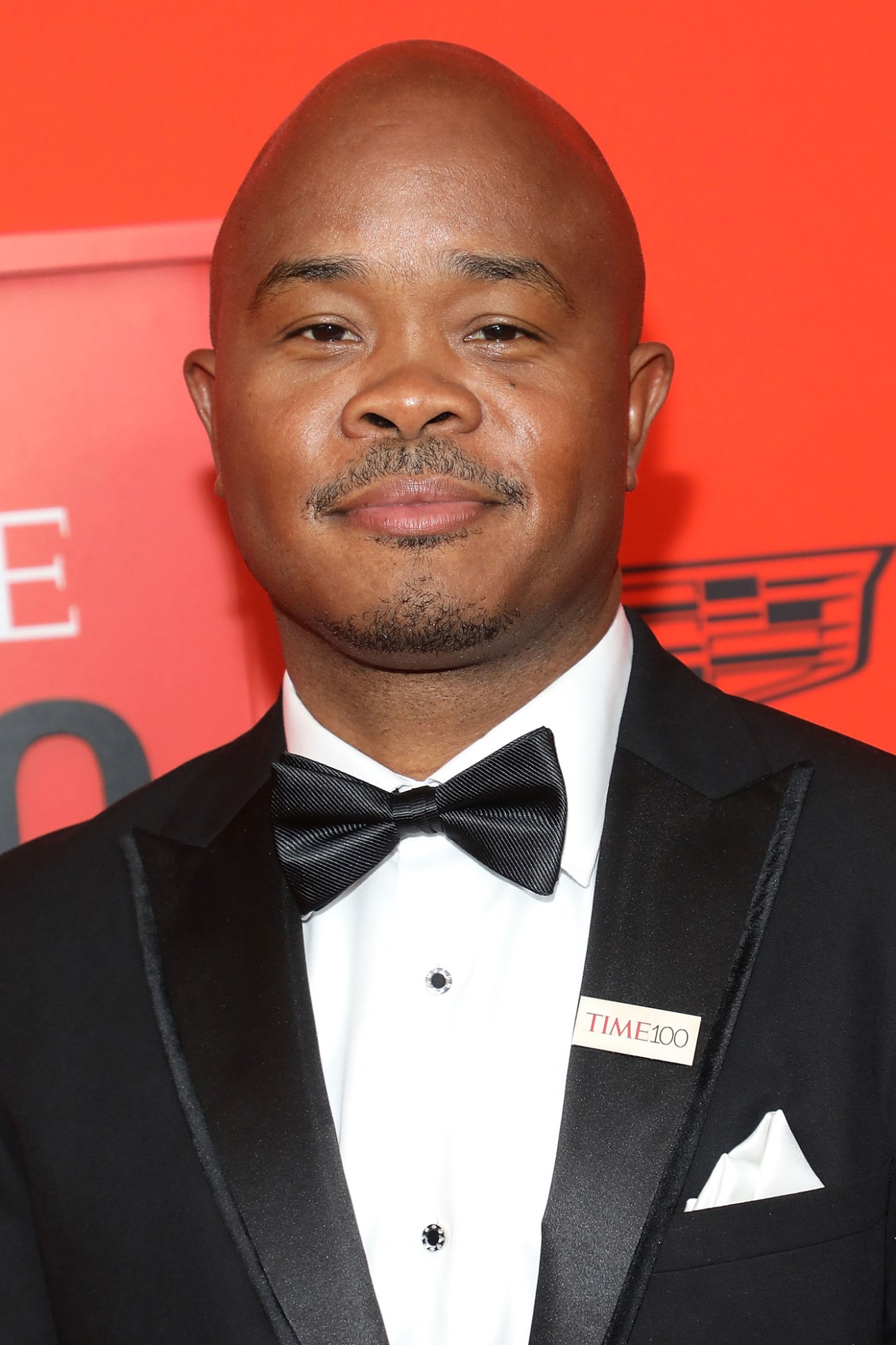 Fred Swaniker, founder of African Leadership University, at a formal event wearing a black tuxedo with bow tie.