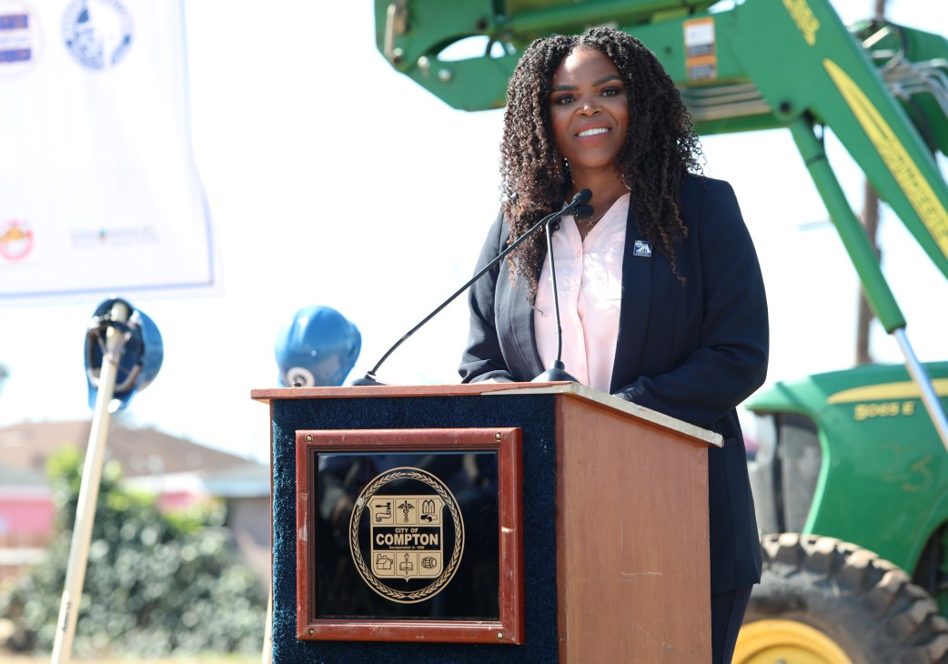 Compton mayor Aja Brown speaking at a podium with City of Compton seal