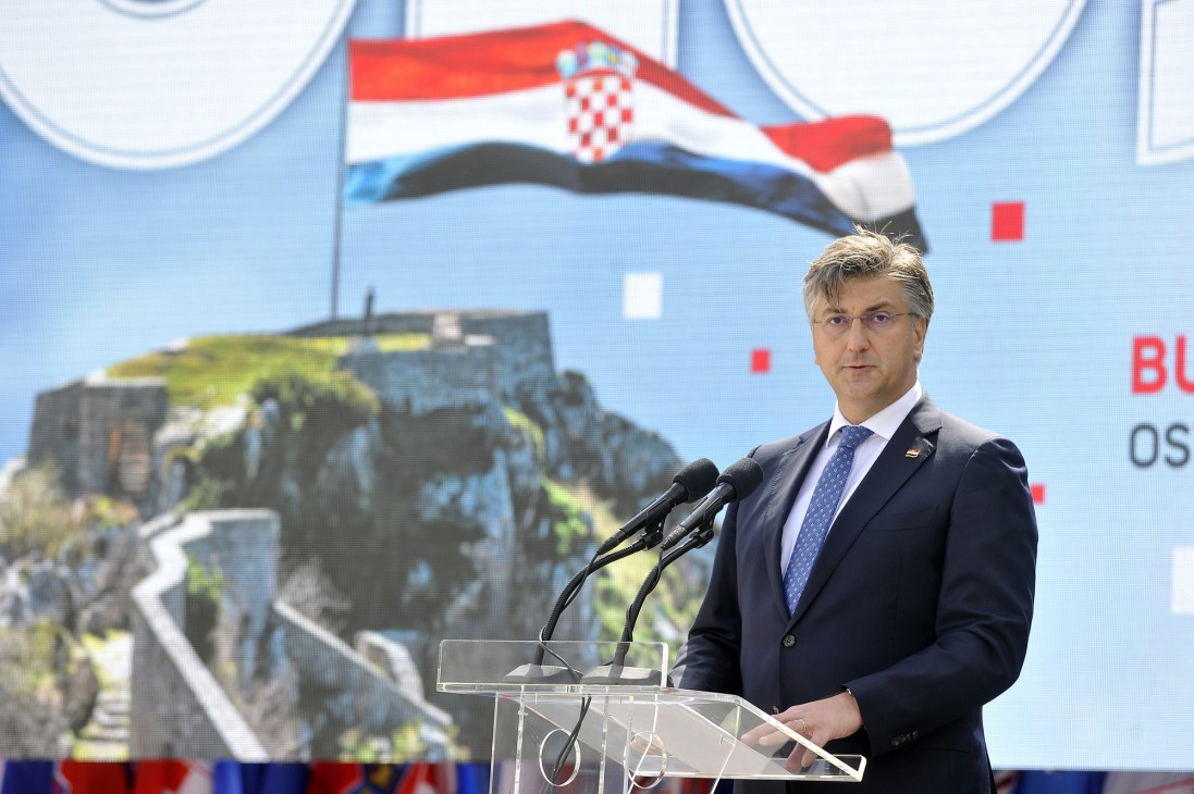 Croatia's prime minister Andrej Plenkovic speaking at a podium with Croatian flag in background