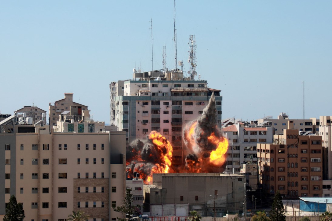 Israeli airstrike destroys al-Jalaa Tower in Gaza City with smoke and debris rising from the collapsed building