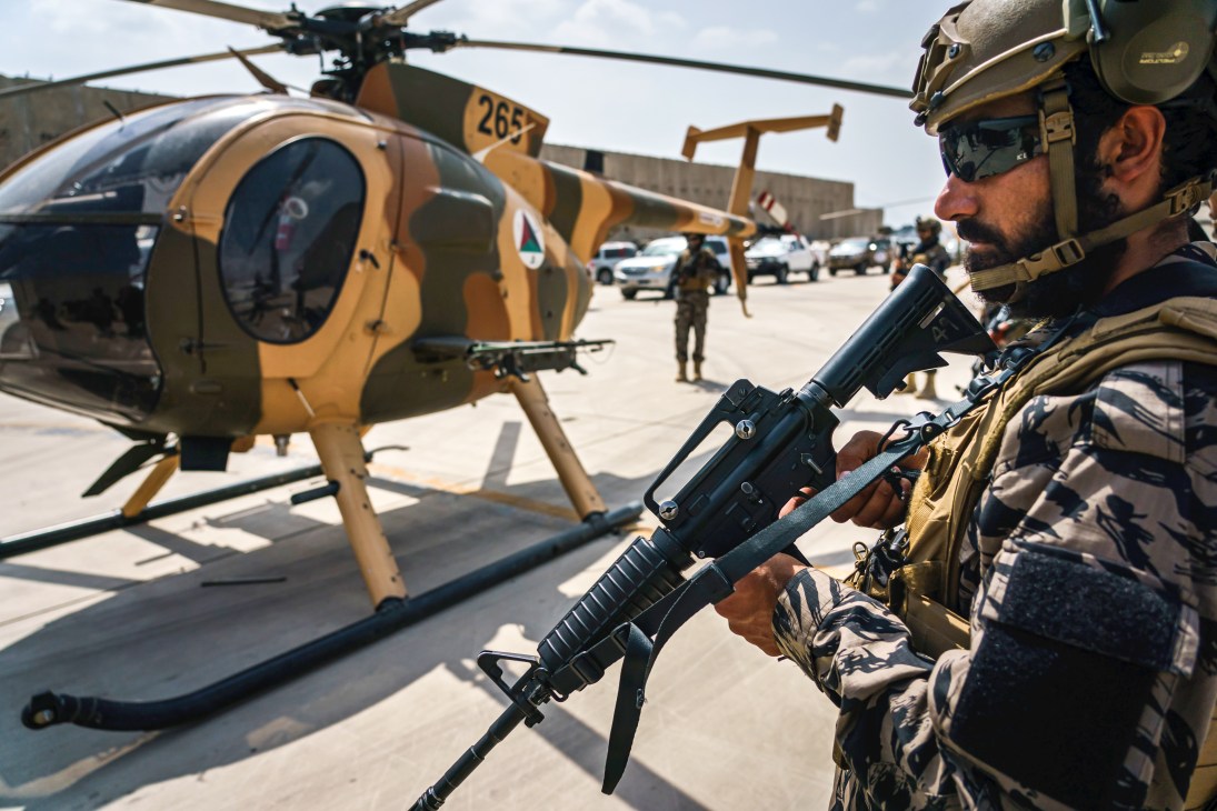 Taliban fighters with weapons secure Kabul airport after US military withdrawal