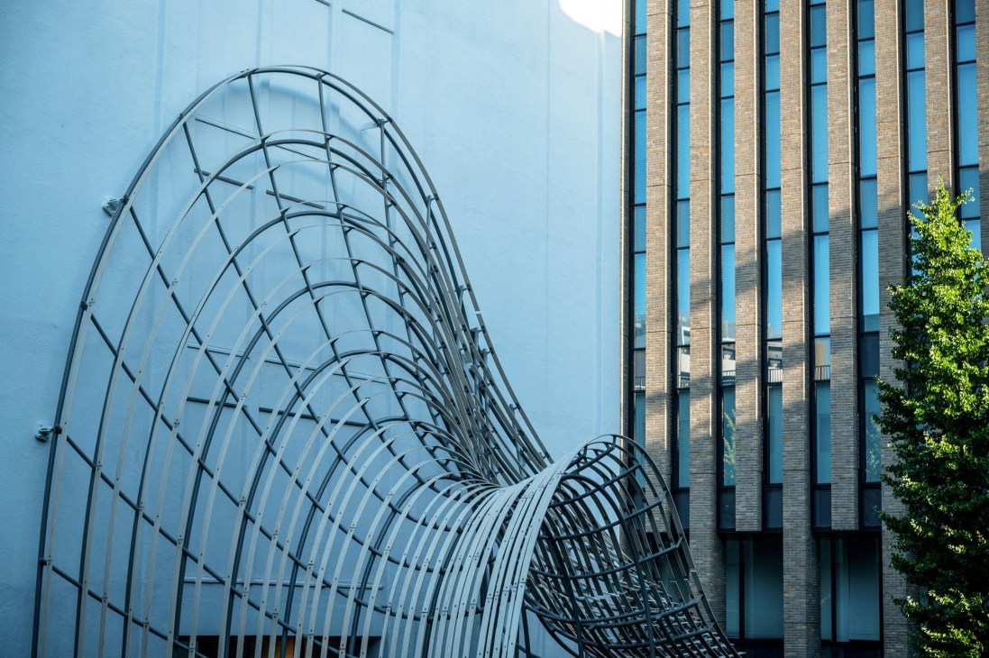 Modern glass and steel architectural structure with curved geometric framework at the Haruki Murakami Library