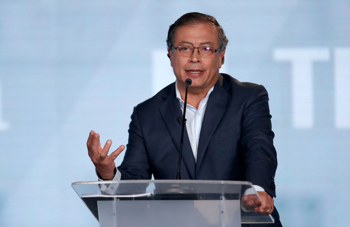Gustavo Petro speaking at a campaign rally surrounded by supporters
