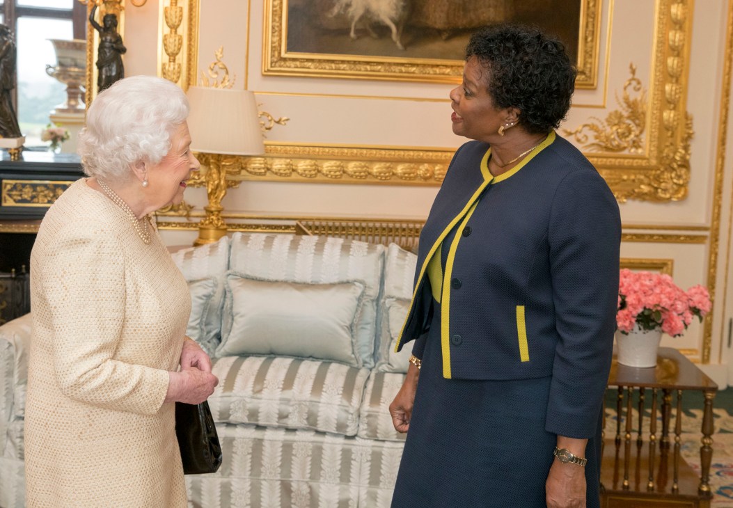 Queen Elizabeth II meeting with Dame Sandra Mason in ornate palace room