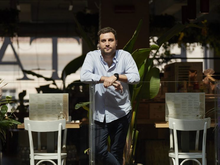 Nicola Farinetti, CEO of Eataly, standing in casual business attire at a restaurant terrace with outdoor seating