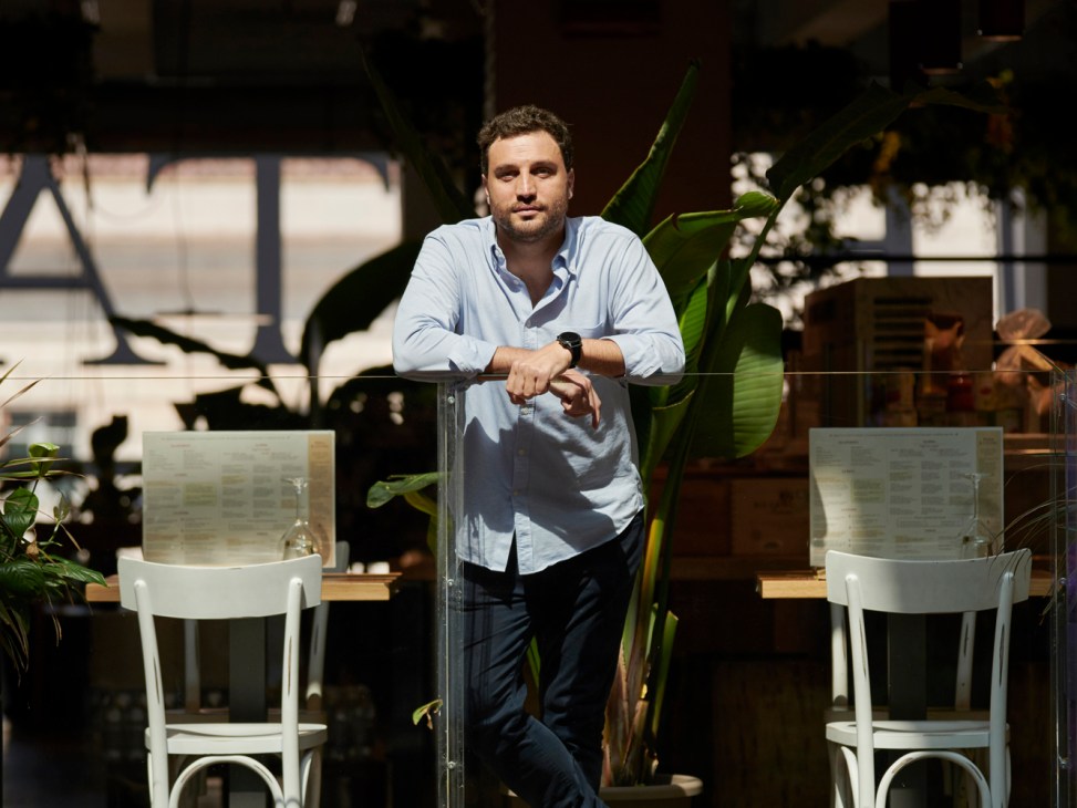 Nicola Farinetti, CEO of Eataly, standing in casual business attire at a restaurant terrace with outdoor seating