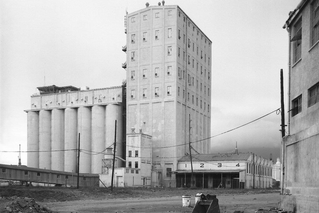 Historic grain silo complex with tall concrete towers and industrial buildings in Cape Town's waterfront area