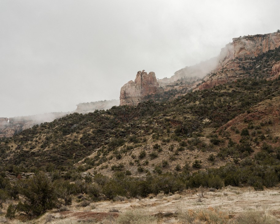 Expansive view of high desert landscape with red rock formations and mesas