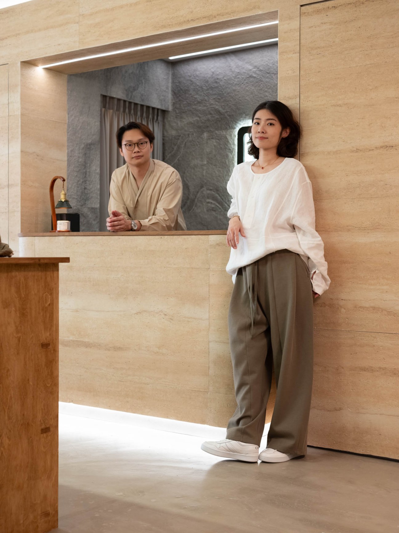 Calvin Sim and Xie Qian Qian standing in their modern minimalist studio space