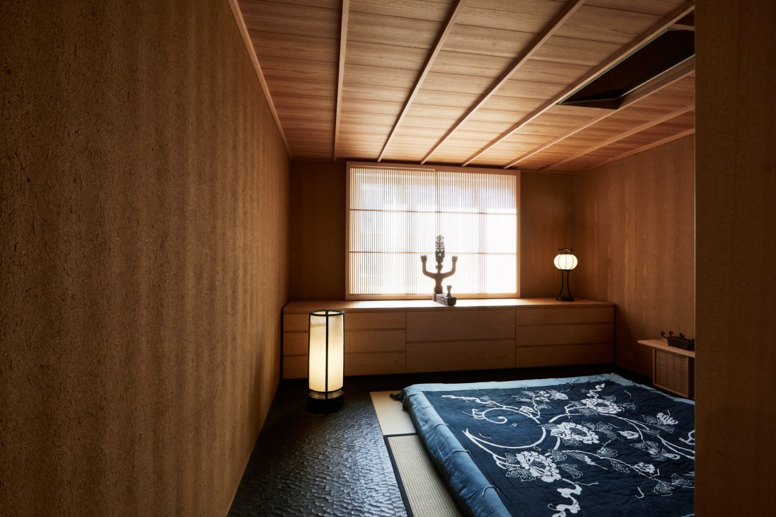 Interior of Hildebrand apartment renovation showing Japanese-inspired design with wood and earthen walls