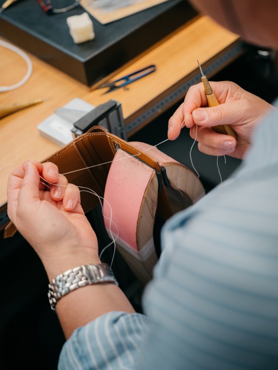 Detail shot of hand-sewn leather stitching showing craftsmanship