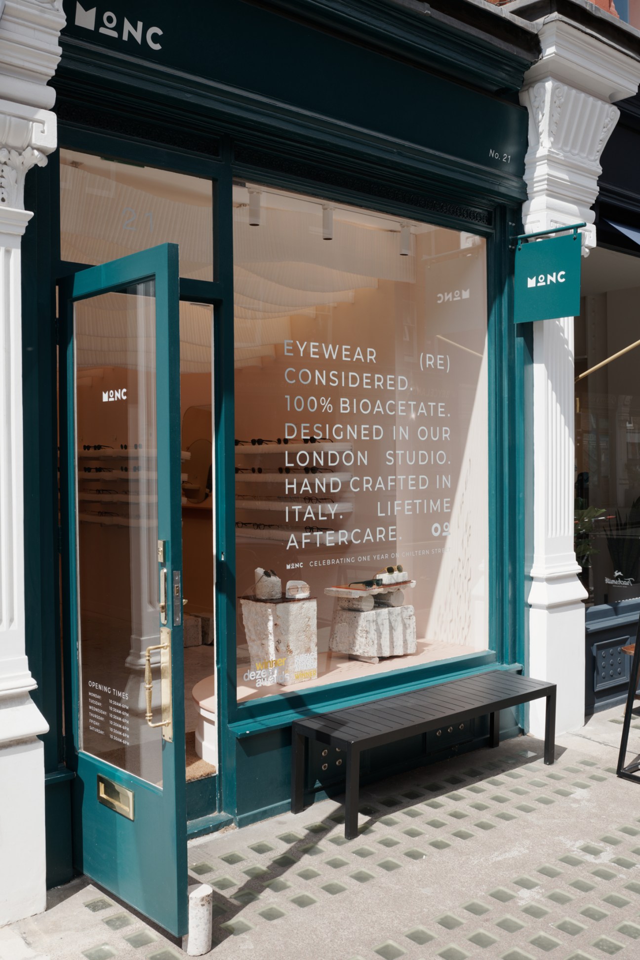 Interior of Monc eyewear shop showing display shelves with glasses frames and modern retail fixtures