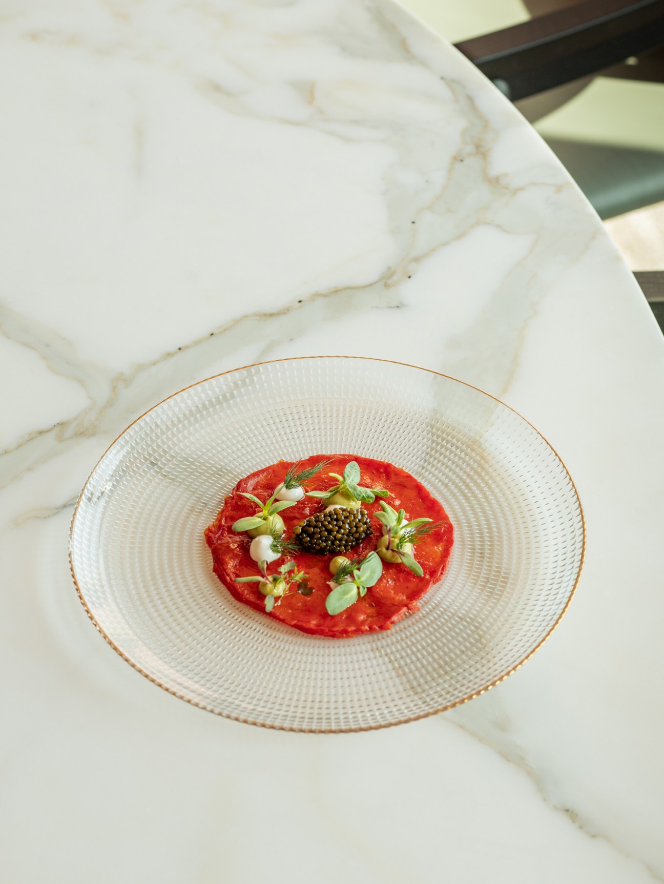 Artistic plating of watermelon carpaccio dish at Carlyle & Co restaurant