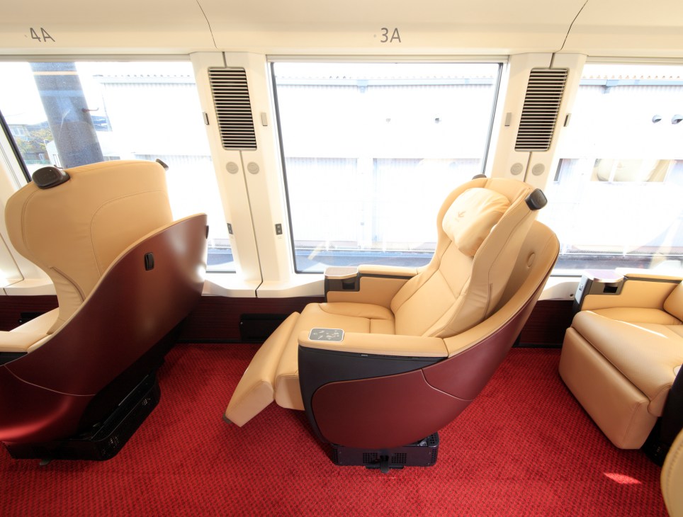 Premium leather seats with shell design and large windows in Hinotori express train interior