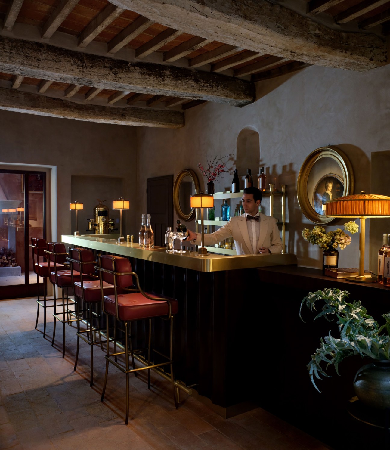 Elegant bar interior with exposed wooden ceiling beams, bartender in light suit, warm lighting and vintage decor