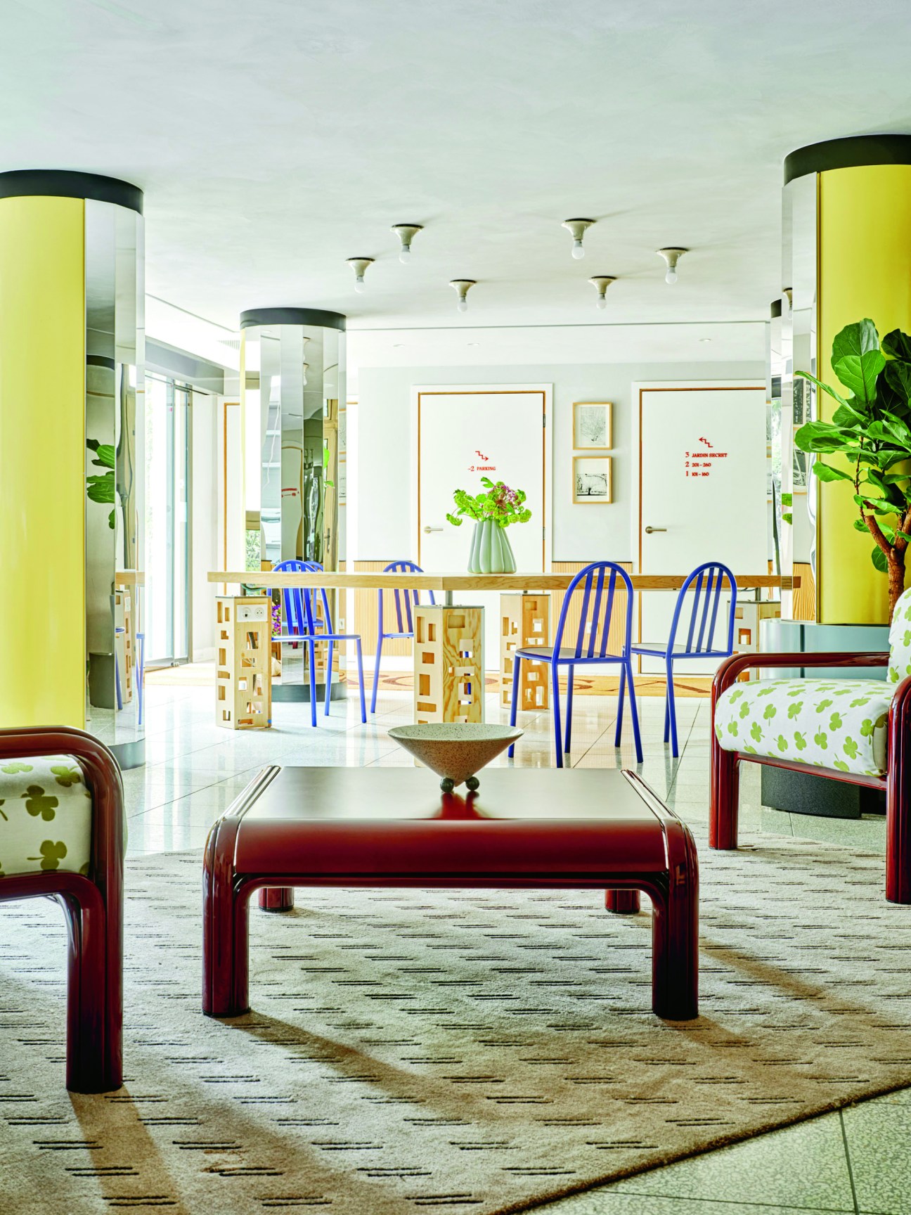 Rosalie hotel lobby featuring contemporary furniture with bright yellow cylindrical columns and modern design elements