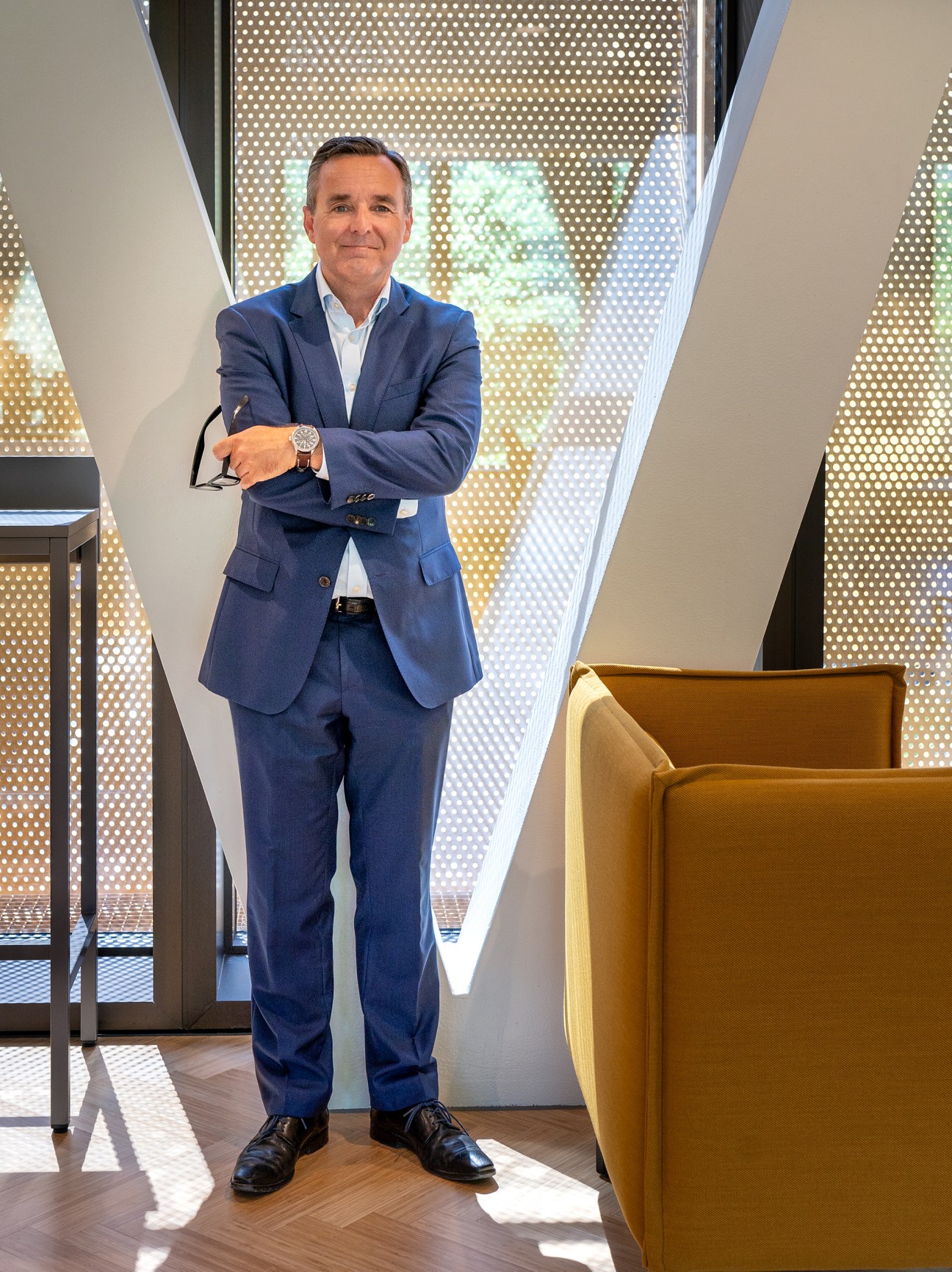 Senior director Jakob Stilov standing in modern office atrium