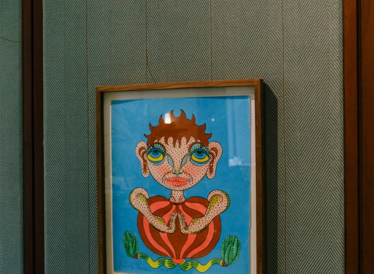 Framed pop art illustration of a wide-eyed figure on a blue background.