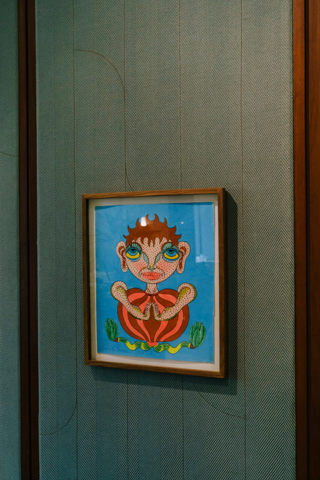 Colorful artistic drawing from Keiichi Tanaami's 'Dream Diary Drawings' series displayed on restaurant wall