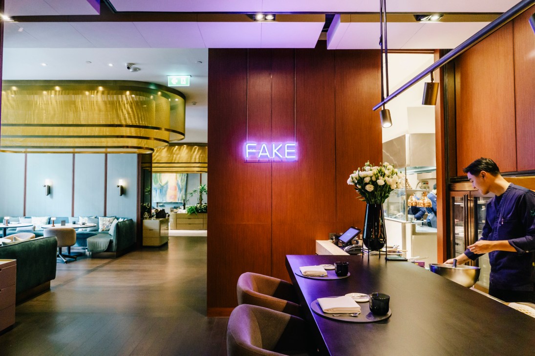 Interior view of upscale restaurant with contemporary artwork on walls and elegant dining setup