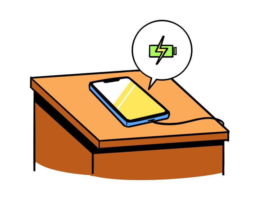 Smartphone with charging battery icon on wooden nightstand surface