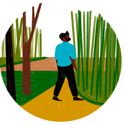 Person in blue shirt walking on yellow path through park with tall bamboo trees