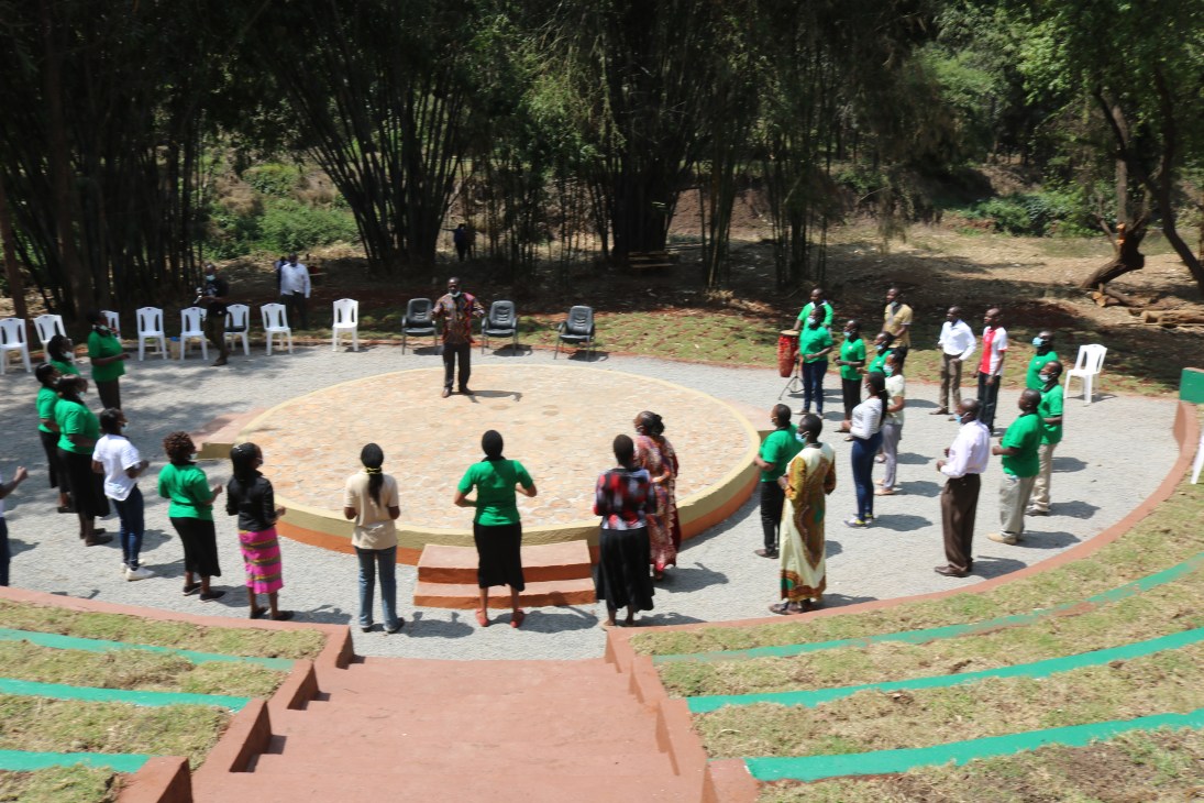 People gathered around a circular paved area with steps in Michuki Memorial Conservation Park in Nairobi