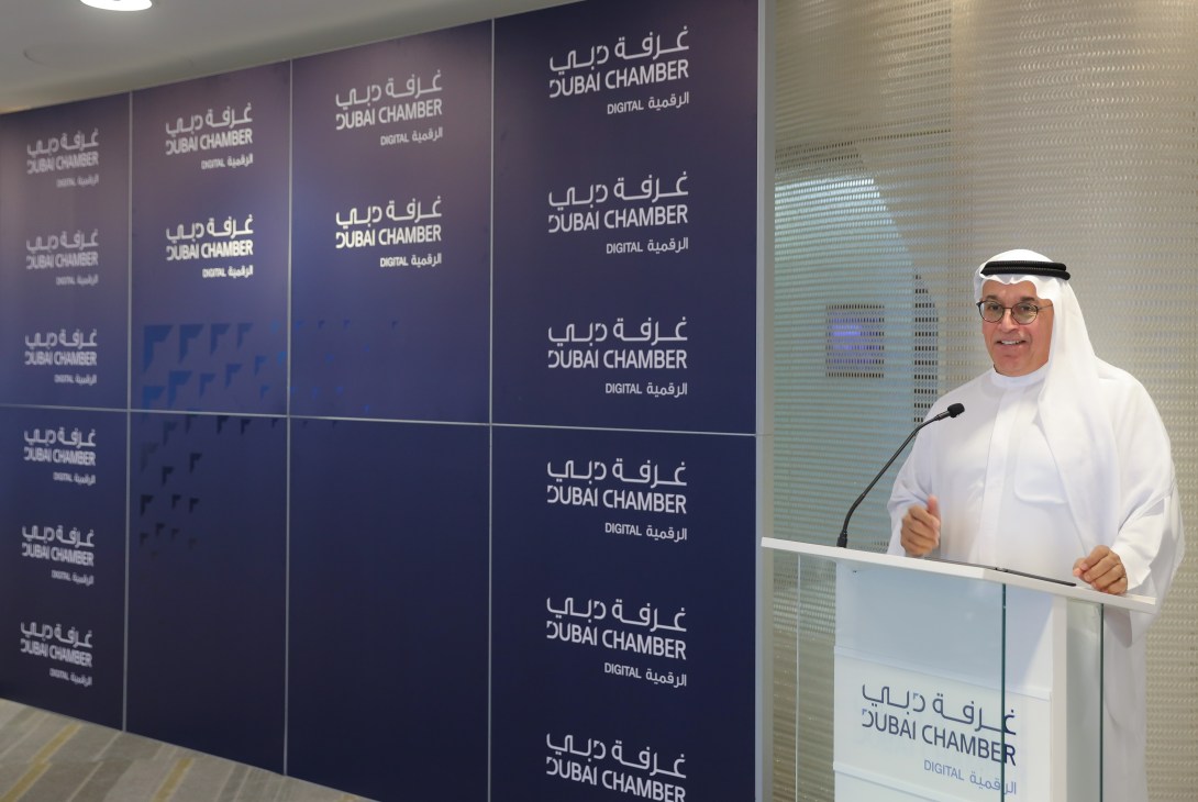 Ahmad Bin Byat speaking at a podium during a Dubai Chamber of Digital Economy event.