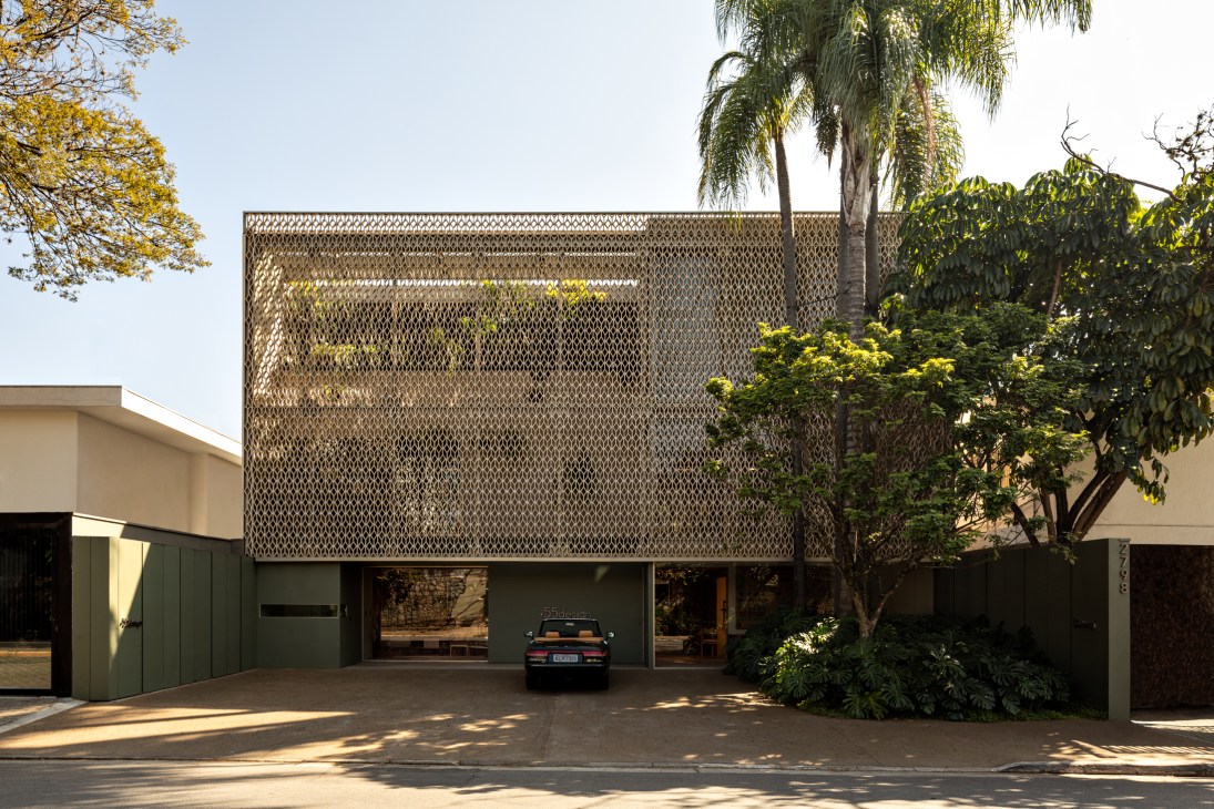 +55design showroom facade with perforated metal screen and covered parking area in São Paulo