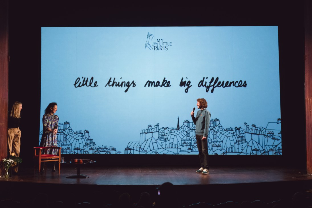 My Little Paris employee presents on stage at Théâtre de l'Atelier during Megalab event with company branding displayed.