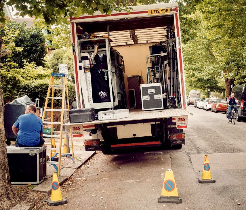 Film crew and equipment working on a road location shoot