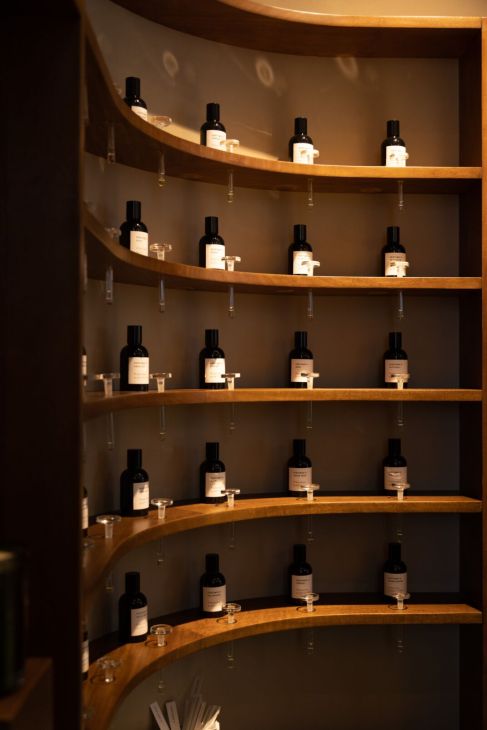 Interior view of Perfumer H boutique showing minimalist design with wooden fixtures and glass testing displays
