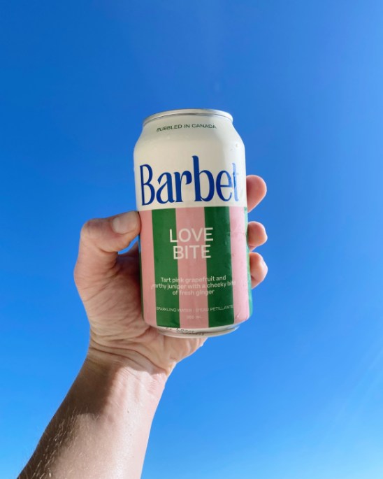 Barbet sparkling drinks cans with colorful striped design displayed on white surface