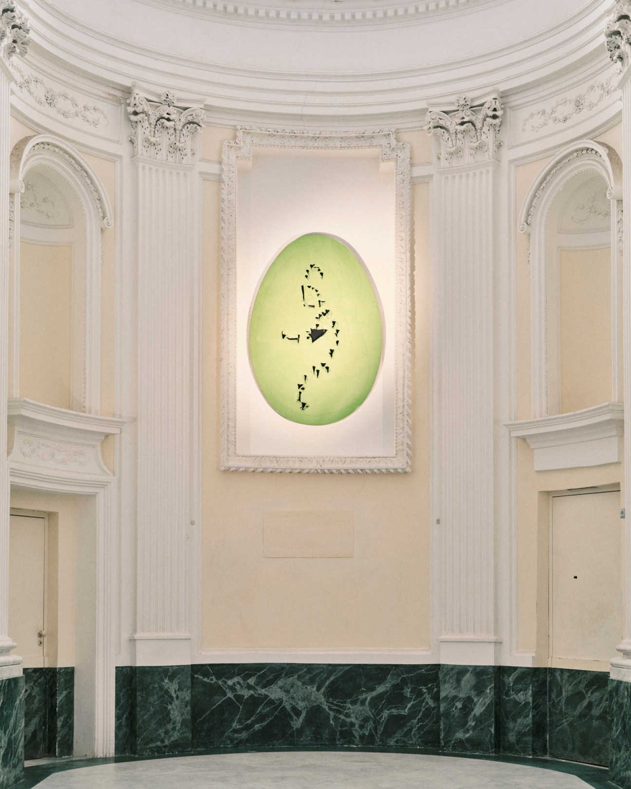 Lucio Fontana's 'The End of God' artwork displayed in ornate classical interior with white columns and green marble