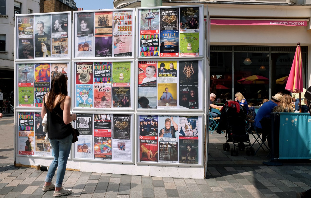 Newspaper stand in Milan featuring local publications and event flyers