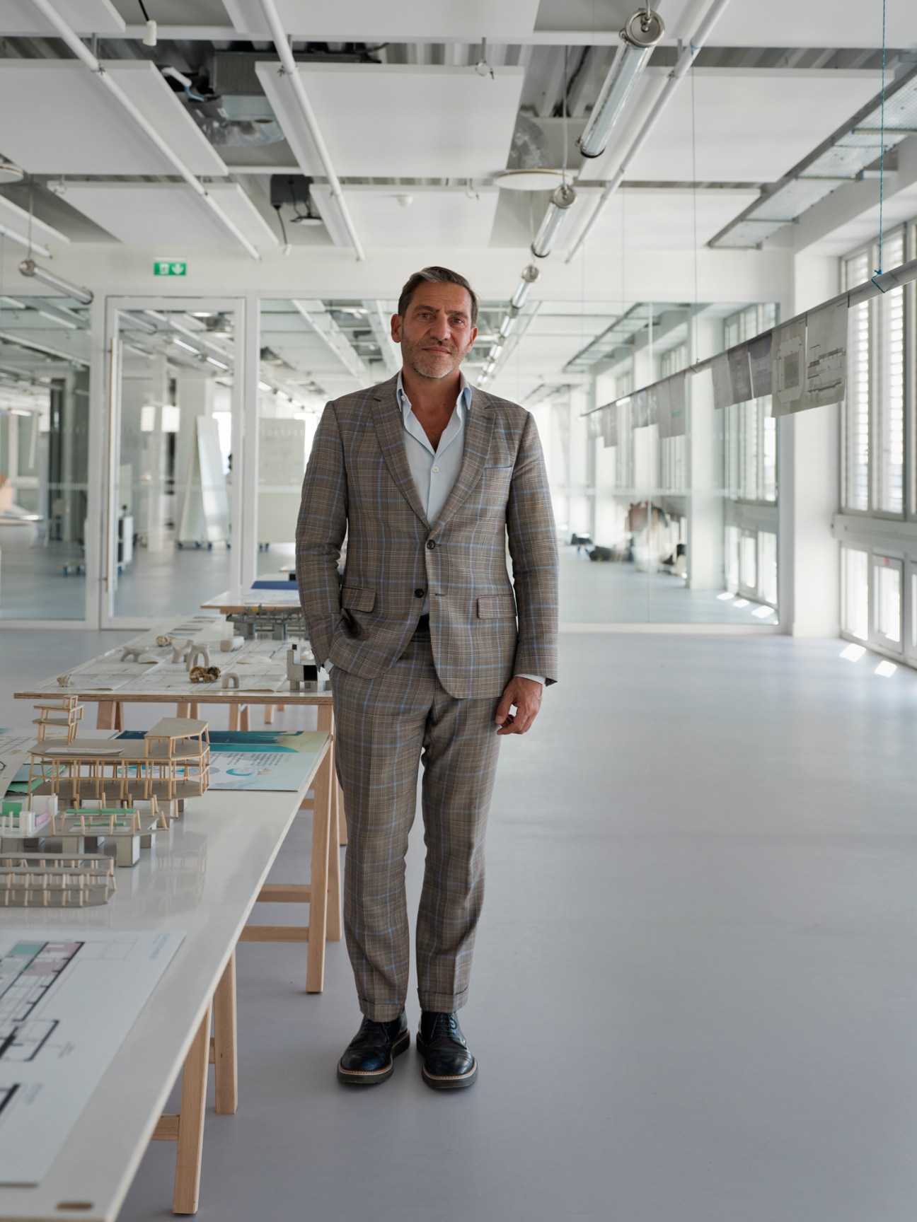 René Jacques Mayer, director of Camondo Méditerranée, stands in a bright modern workshop with architectural models on tables.