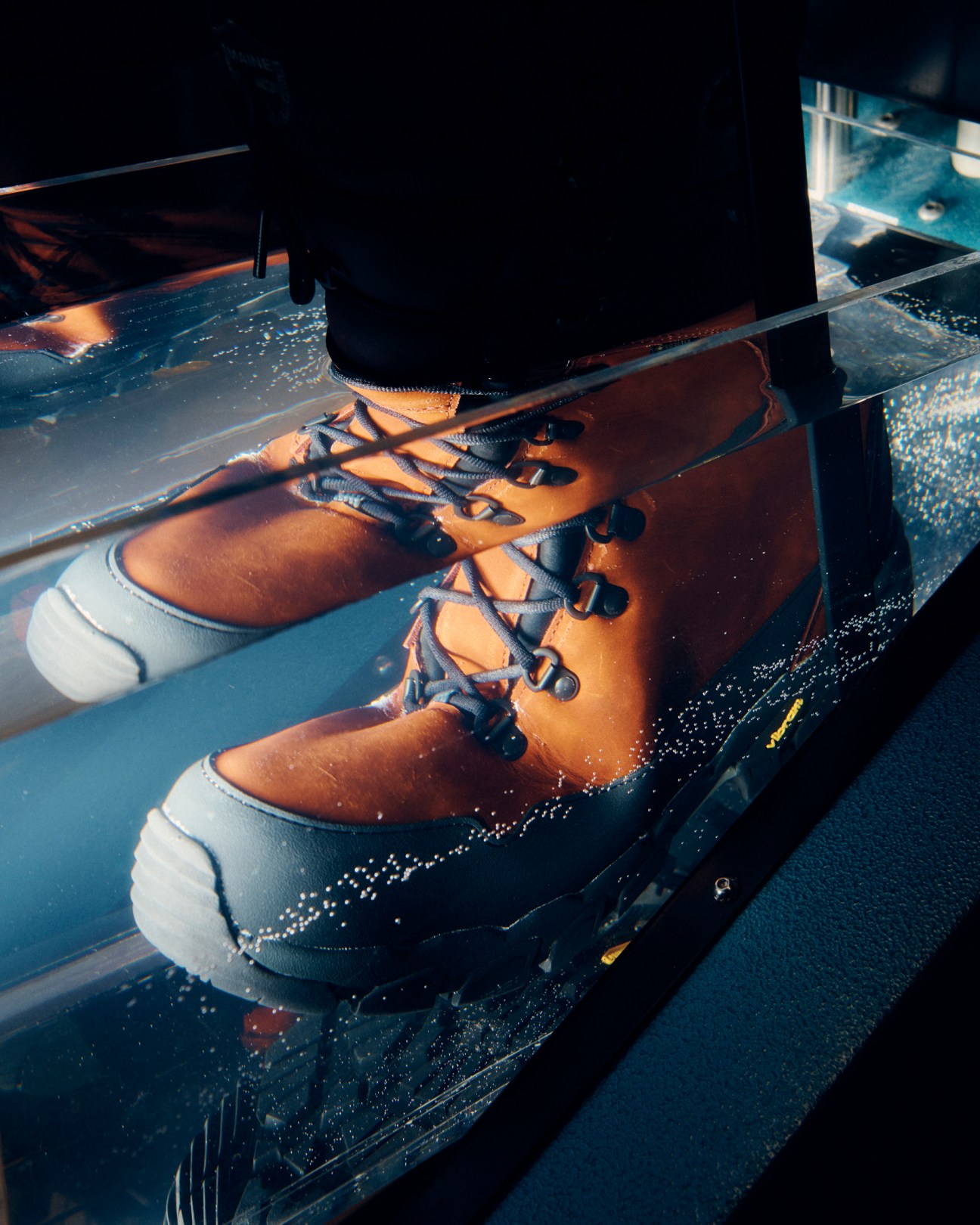Leather boots being tested in water tank with bubbles