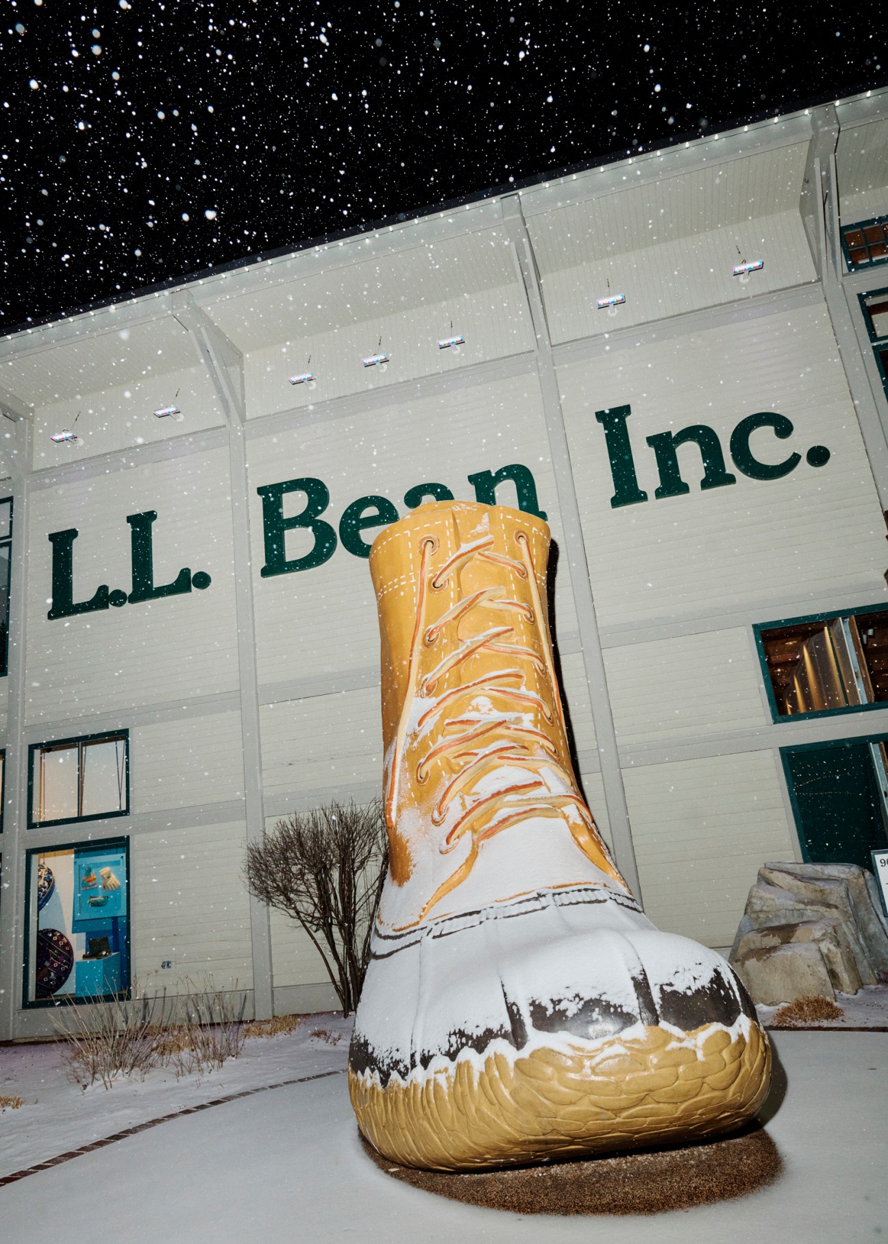 Giant LL Bean boot sculpture covered in snow outside the Freeport flagship store at night