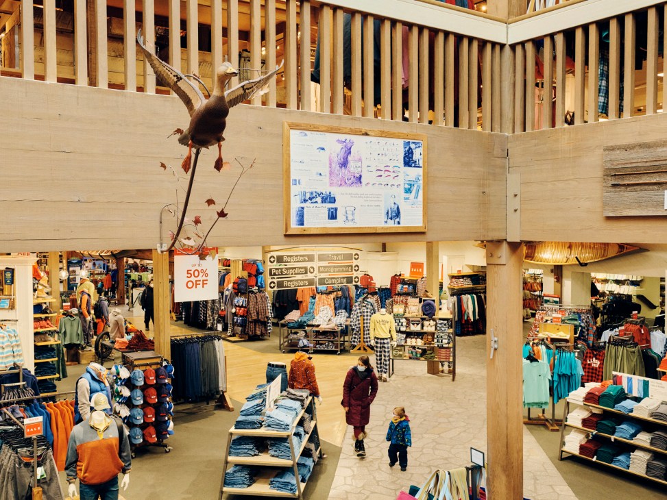 Interior view of LL Bean's flagship store in Maine showing multiple levels with wooden railings and shoppers below