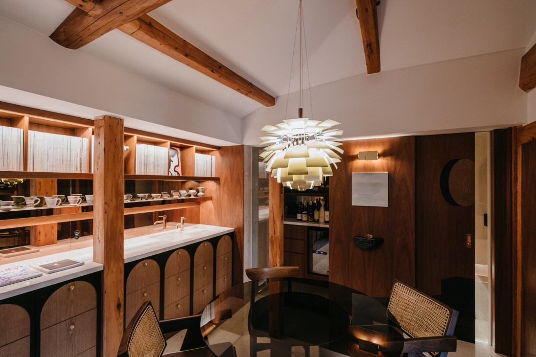 EATH Library's archive reading room at Teo Home with wooden shelving, pendant light and modern furniture